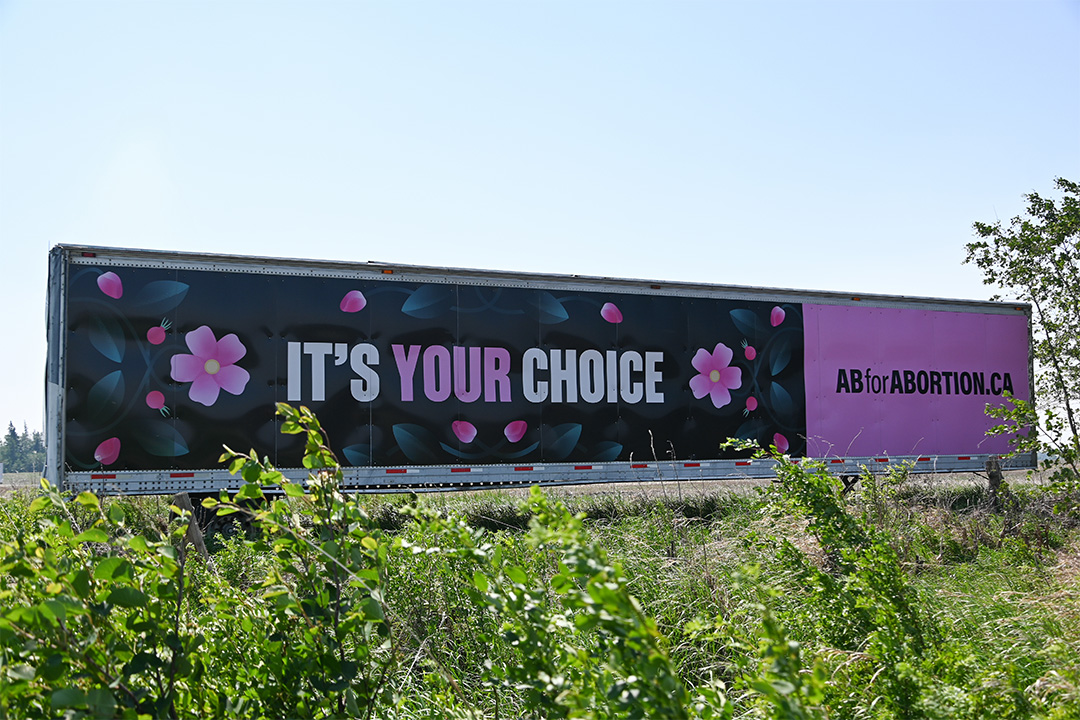 AB for Abortion's pink billboard with "It's your choice" written on it.