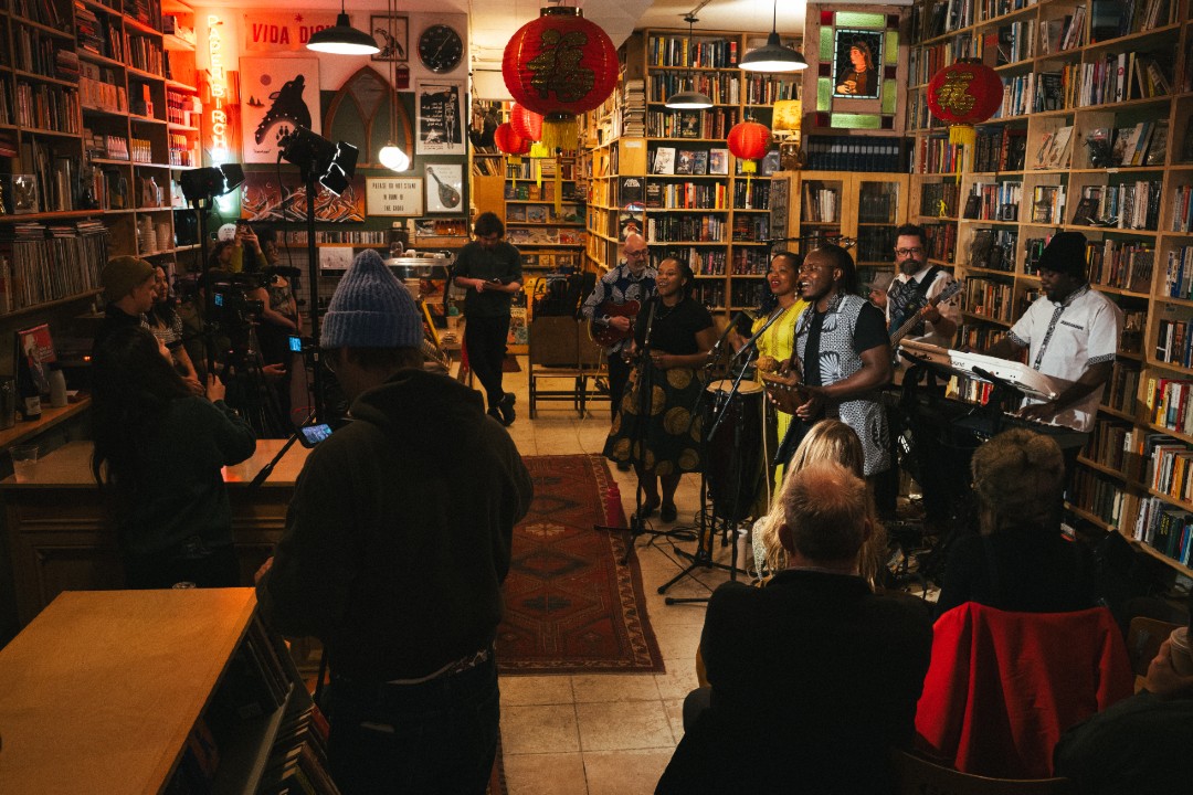 Musicians, a video crew, and concert attendees squeezed into a book store.
