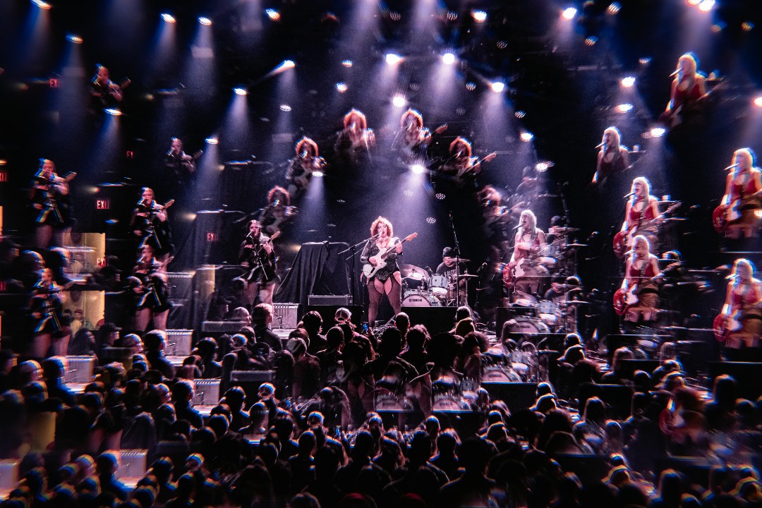 The band Bad Buddy on stage in a kaleidoscopic photo illustration
