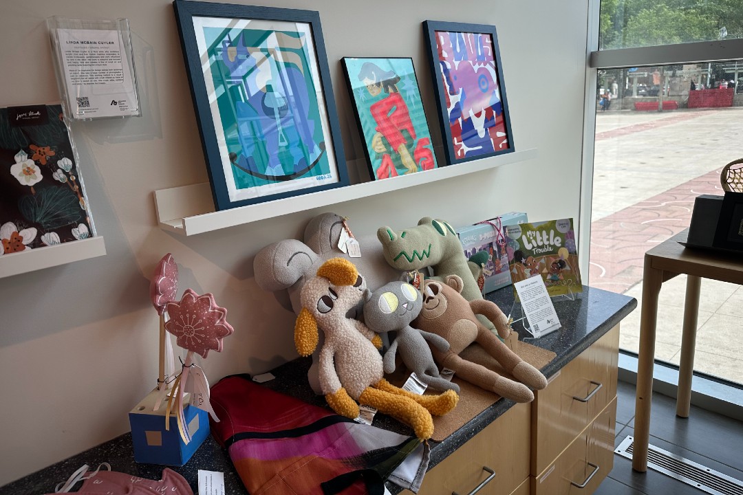 Shelves with painted artworks and stuffed animals