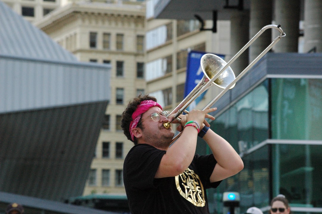 A trombonist performs outdoors