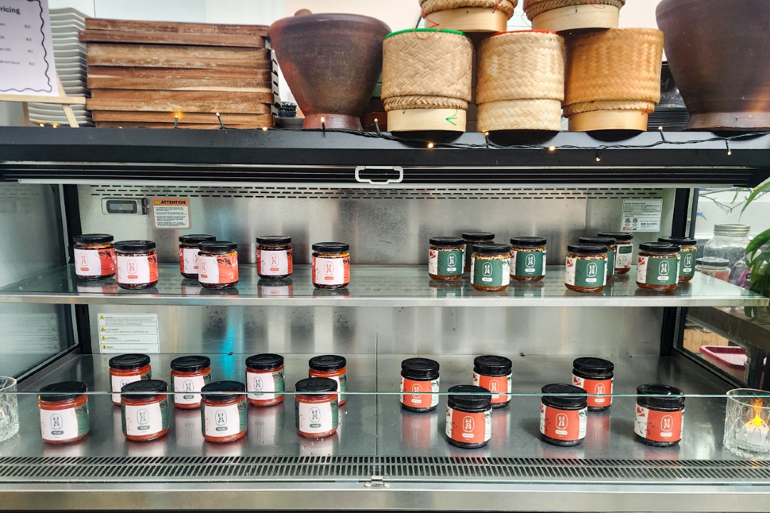 Jars of condiments labelled HOM on shelves