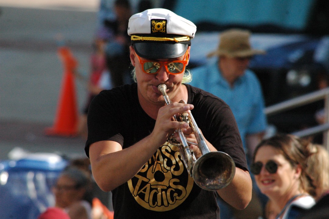 A trumpet player wearing a nautical hat