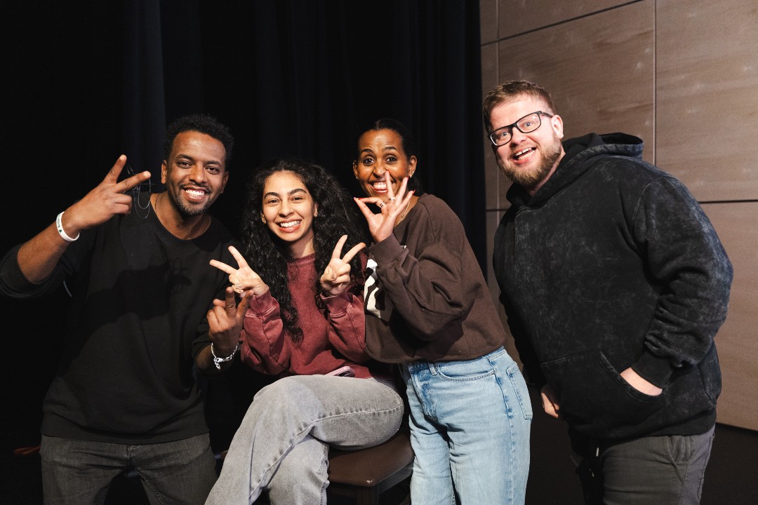 Four smiling people pose for a photo