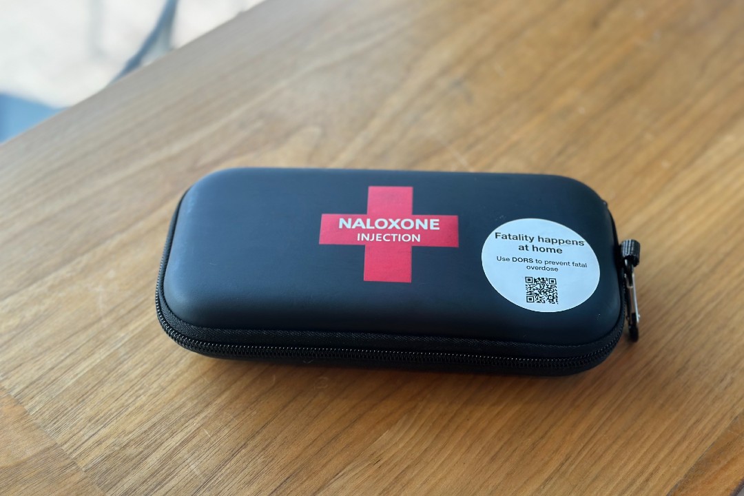 A black and red naloxone kit