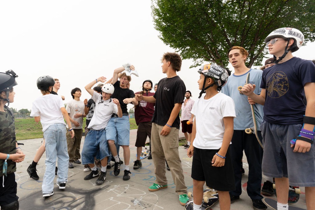 A group of skateboarders in a skate park