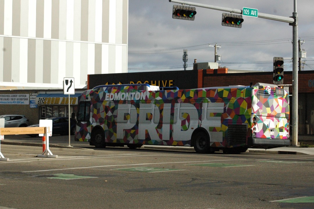 An Edmonton Transit Service bus wrapped in multi-colours with the words Edmonton Pride