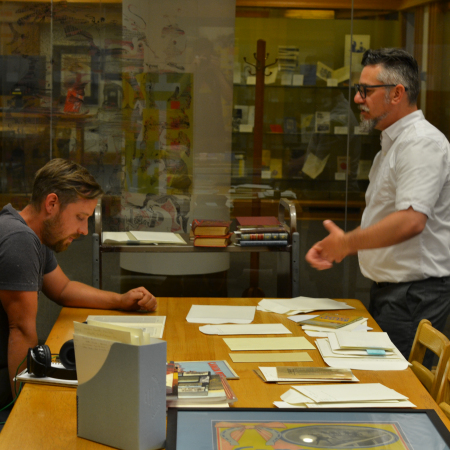 Jeff Papineau and Dustin Bajer look through materials at the Bruce Peel Special Collections
