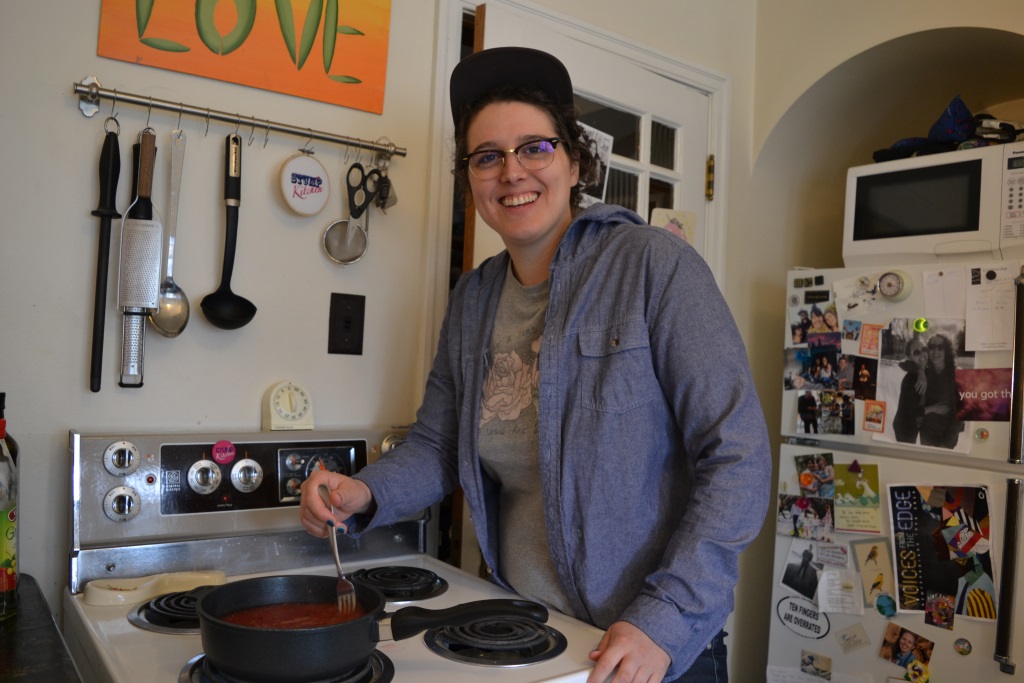 Alison stirring a pot of kalyna juice in her kitchen